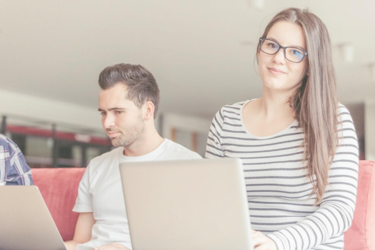 Student analyzing financial charts and company reports in classroom setting